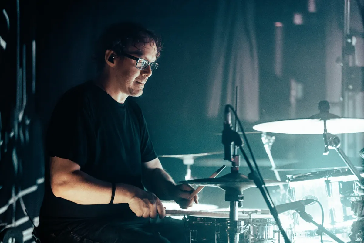 Drummer portrait with moody teal side-lighting